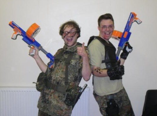 Two happy men with big NERF guns